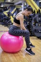 Woman doing a workout with dumbbells at the fitness gym. photo