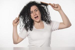 beautiful female with comb stuck in curly hair photo