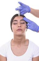 young woman gets injection of botox. anti-aging injection photo