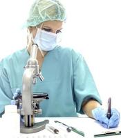 Scientist in blue medical gloves and uniform learning COVID-19 samples with microscope in laboratory. photo