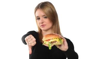 portrait of a beautiful funny young girl eating hamburger photo