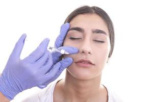 young woman gets injection of botox. anti-aging injection photo