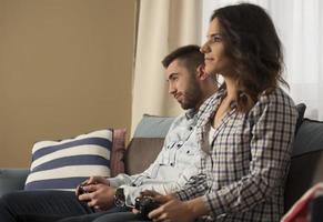 happy smiling couple playing video games at home. photo