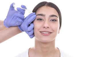 young woman gets injection of botox. anti-aging injection photo