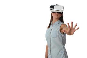 Pretty cute excited female in VR headset looking up and trying to touch objects in virtual reality photo