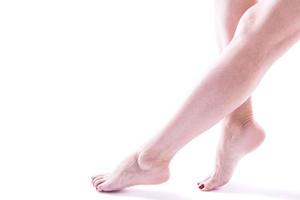beautifully groomed female legs on a white background photo