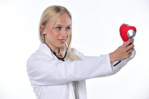 cardio heart surgeon hands holding red heart shape on white background photo