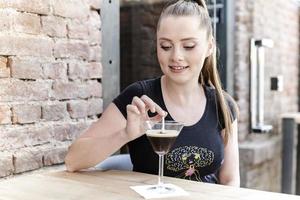 woman's picking a martini glass filled with delicious chocolate coffee martini with sprinkles photo