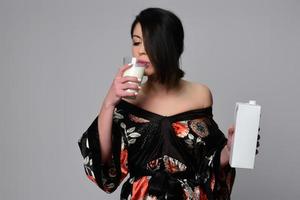 woman holding and drinking milk. photo