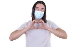 Asian male model wearing and holding surgical face mask and protective gloves