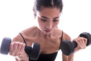 young sporty Asian woman with dumbbells photo