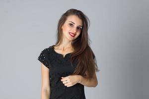girl in black dress posing in studio photo