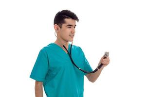 stylish elegant doctor in blue uniform with stethoscope posing isolated on white background photo