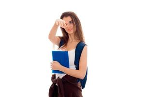 beautiful young girl in white shirt and with a Briefcase holding a blue folder and covering her face photo