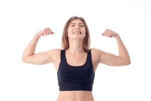 cheerful athletic girl laughs and shows muscle on hand isolated  white background photo