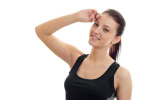 girl in black t-shirt that keeps your hand near the face and a smiling of isolated on white background photo