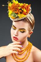 Sensual portrait of young fashion model with rowan in hair and neck photo