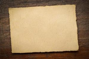 sheet of blank handmade paper with rough edges photo