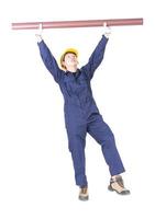 Plumber in uniform holding pvc pipe on white photo