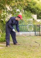 Gardener with garden tools at work photo