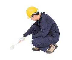 Worker in a uniform using a paint roller is painting invisible floor photo