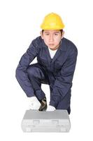 Young handyman sitting with his tool box photo