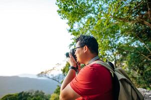 Young trekking man use camera photograph beautiful view photo