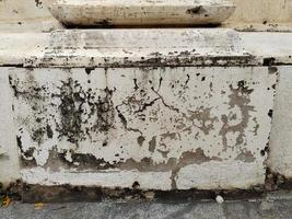 White wall are damaged by water causing mold, lichen and paint peeling photo