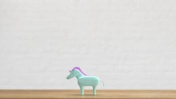 el unicornio en la mesa de madera para la representación 3d del concepto de negocio foto