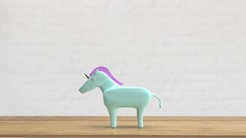 el unicornio en la mesa de madera para la representación 3d del concepto de negocio foto