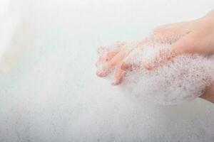 Child washing hands  in foam
