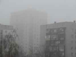 Foggy city with the houses photo