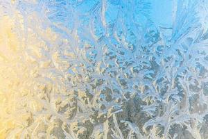 Frozen winter window with shiny ice frost pattern texture. Christmas wonder symbol, abstract background. Extreme north low temperature, natural Ice snow on frosty glass, cool winter weather outdoor. photo