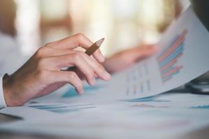 Business people read business statistics chart reports, to analyze and improve corporate strategy, manage financial and marketing documents, update annual budget accounts, company growth data. photo