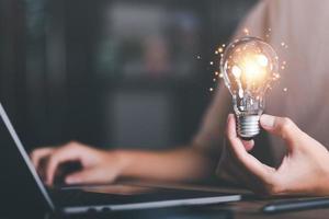 for Concept new idea, concept with innovation and inspiration, innovative technology in science concept and modern business development,creative idea,man holding a light bulb photo