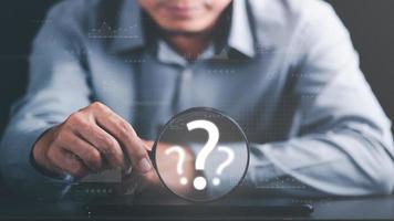 young man holding a magnifying glass Displays a search for information he is interested in through online websites,keyword search concept to find information from online websites,website link search photo