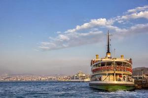 Ferry at a pier to get passengers on a sunny day at Istanbul, Turkey photo