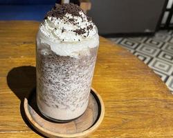 iced frappe chocolate drink with whipped cream on top and grated chocolate crunch photo