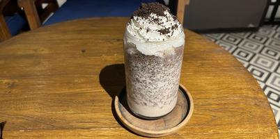 iced frappe chocolate drink with whipped cream on top and grated chocolate crunch photo