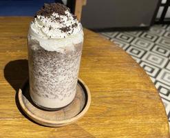 iced frappe chocolate drink with whipped cream on top and grated chocolate crunch photo