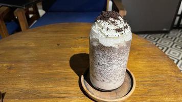 iced frappe chocolate drink with whipped cream on top and grated chocolate crunch photo