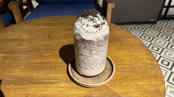 iced frappe chocolate drink with whipped cream on top and grated chocolate crunch photo