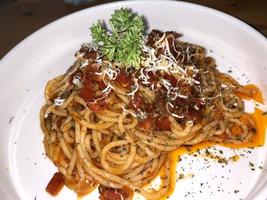 Delicious Spaghetti Bolognese, Pasta with meat, tuna, and tomato sauce and vegetables photo