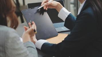 Business and lawyers discussing contract papers with brass scale on desk in office. Law, legal services, advice, justice and law concept picture with film grain effect video