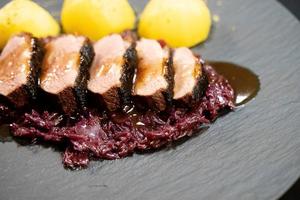 christmas dinner fried Duck breast with red cabbage photo