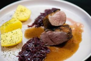 christmas dinner fried Duck breast with red cabbage photo