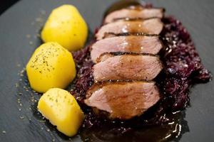 christmas dinner fried Duck breast with red cabbage photo