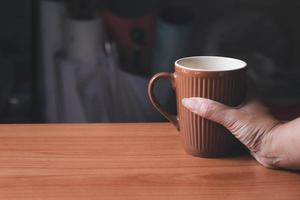 mano sosteniendo una taza de café. copie el espacio foto