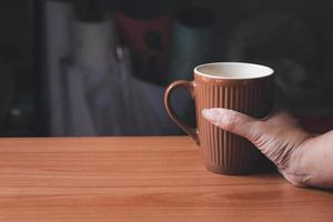 Hand holding a cup of coffee.Copy space photo