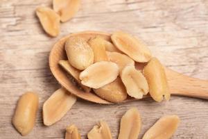 salted roasted peanuts on wooden background photo